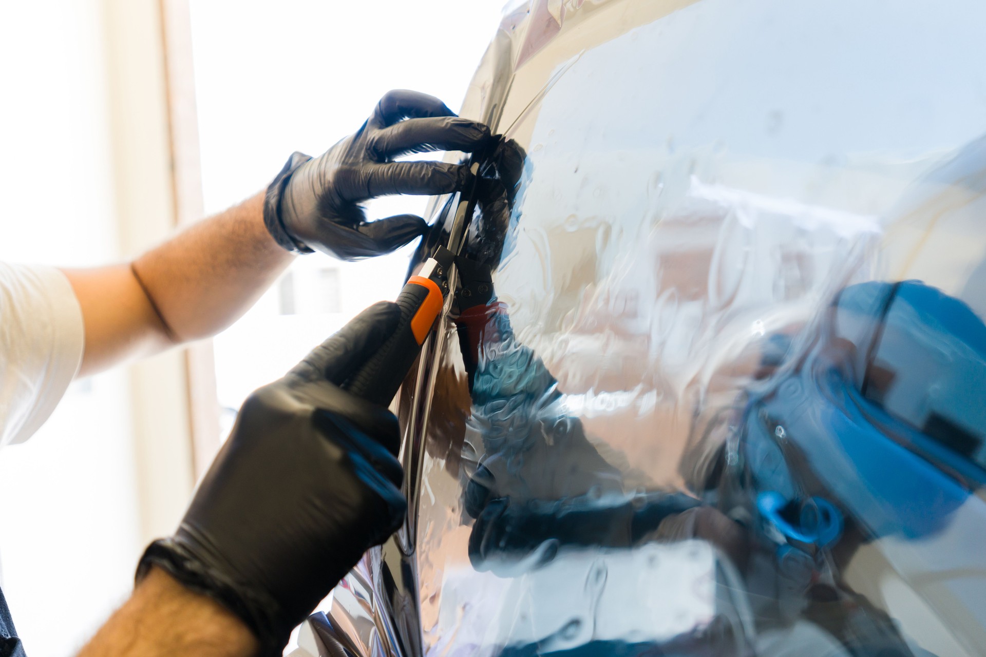 Technician installing car window tint