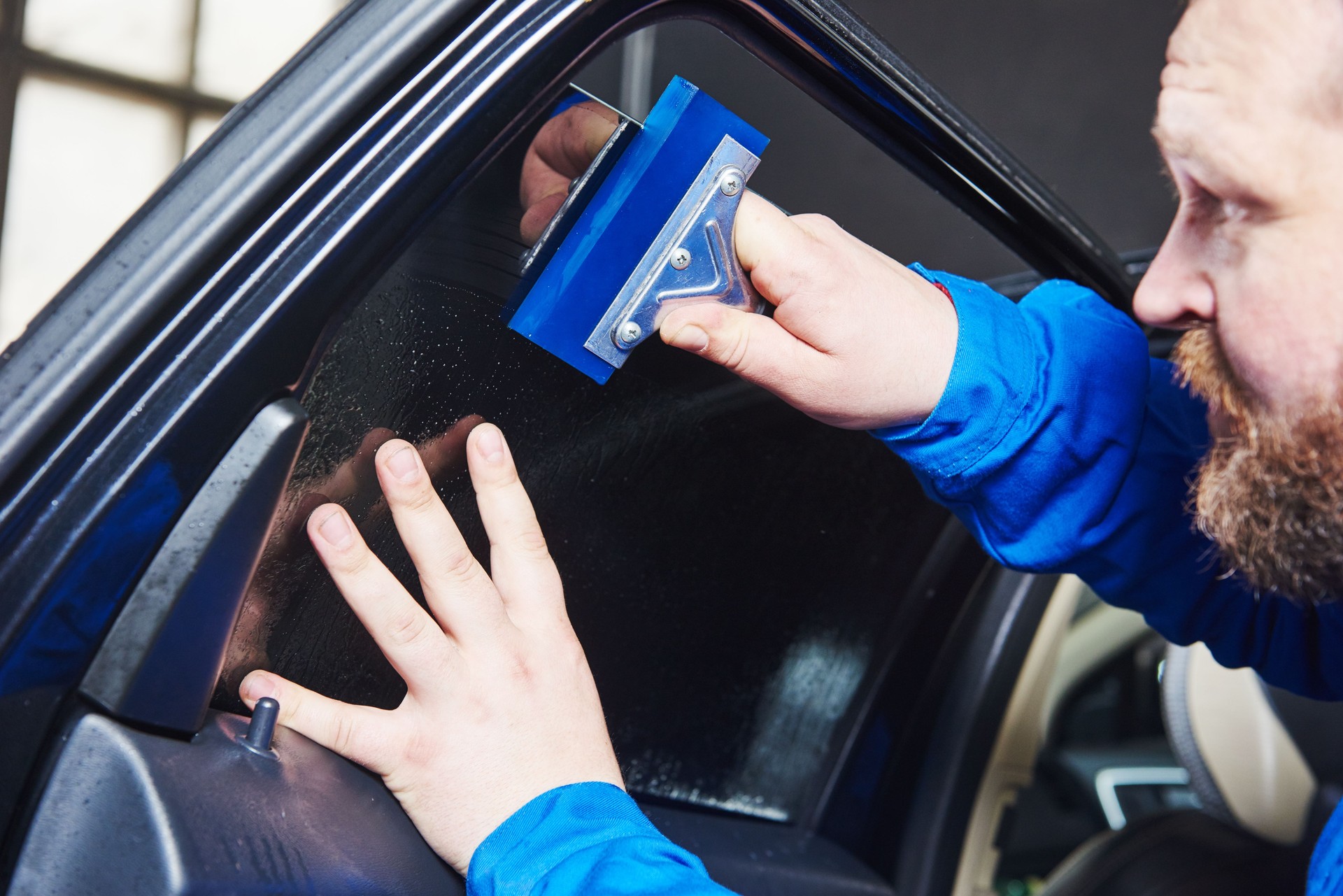 car tinting. Automobile mechanic technician applying foil